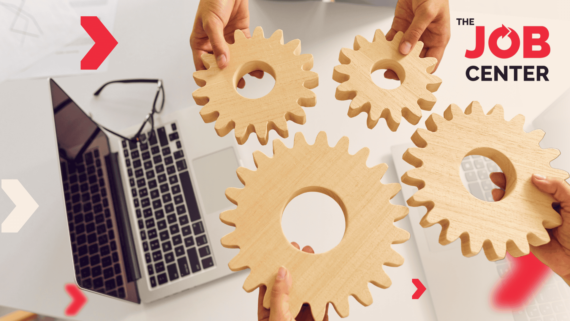 4 hands hold wooden gears beside a laptop and glasses, symbolizing workforce planning for peak season.