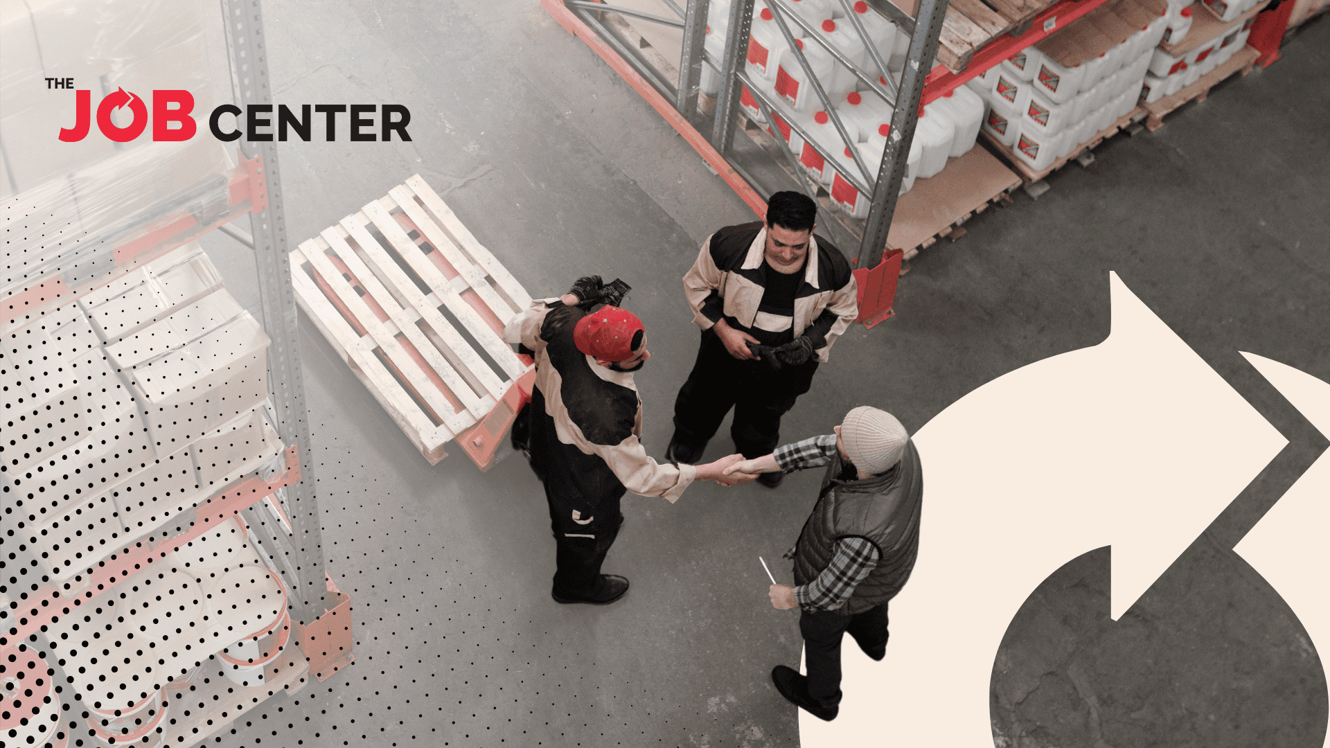 Three warehouse workers stand in a circle, two shaking hands