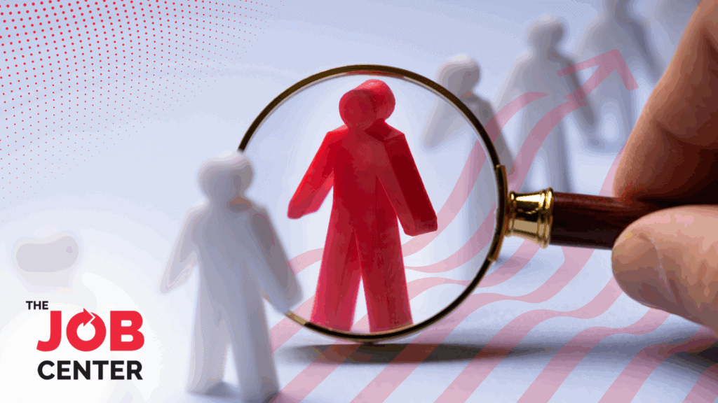 A magnifying glass zooms in on a red figurine among white figures, symbolizing a staffing partner that stands out