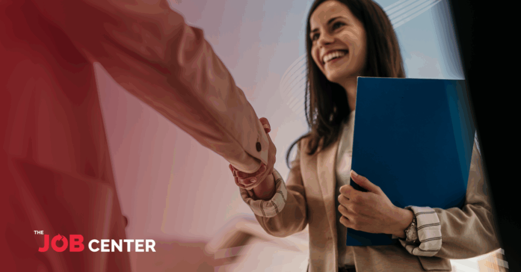 A new hire is welcomed with a handshake